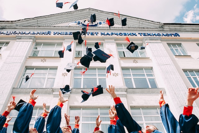 college grads tossing caps